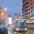 un bus 001 en la gran via de madrid al atardecer
